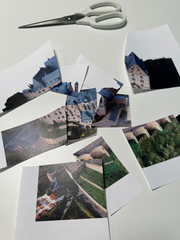 Ausgedruckte Fotos des Marburger Schlosses, mit der Schere in einzelne Teile zerschnitten